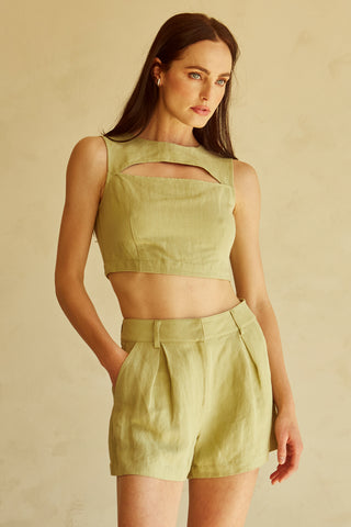 A woman wearing a fern cut-out sleeveless top set.