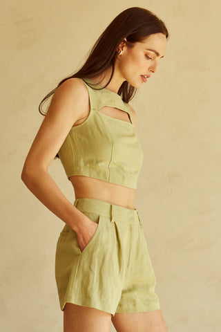 A woman wearing a fern cut-out sleeveless top set.