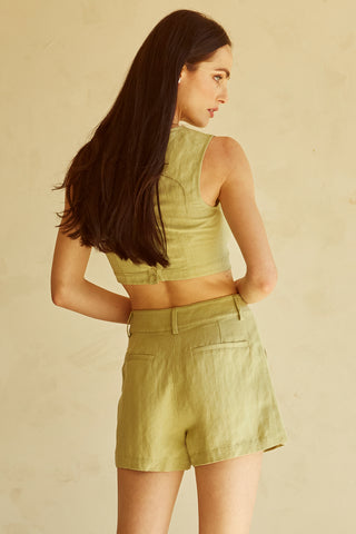 A woman wearing a fern cut-out sleeveless top set.