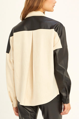model showing back of black vegan leather and suede top