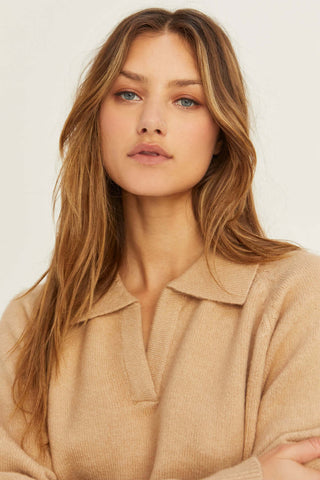 model wearing a beige polo sweater