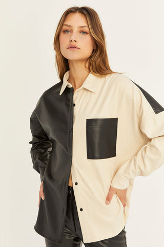 model wearing a black and cream vegan leather shirt
