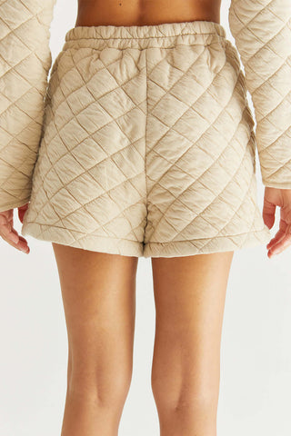 model wearing cute beige quilted shorts