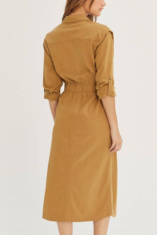 model wearing fitted, button-up utility dress