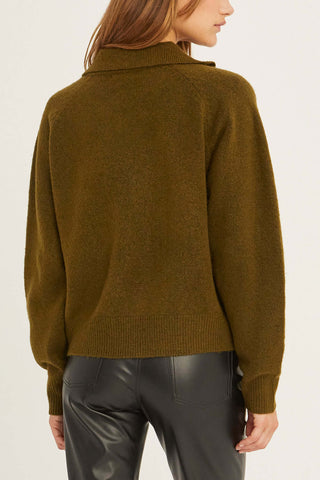 model wearing a green raglan sleeve sweater