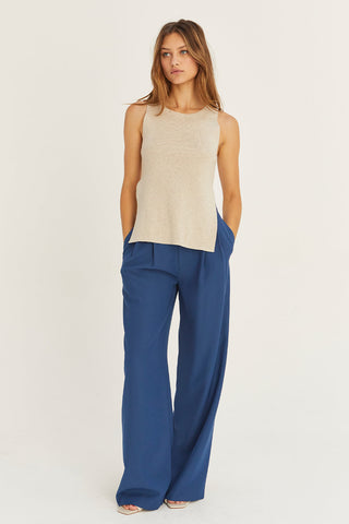 model in beige sleeveless sweater