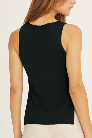 model in black sleeveless sweater