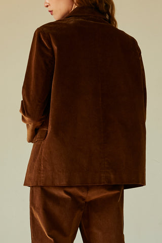 model posing in brown corduroy blazer
