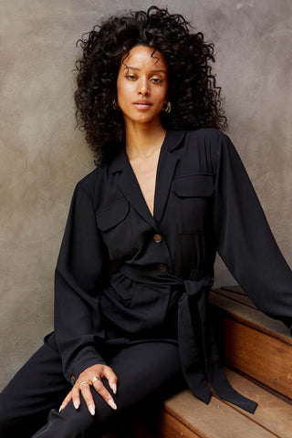 model wearing black jumpsuit