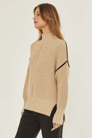 model wearing an oatmeal and black contrast sweater