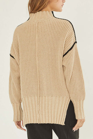 model wearing an oatmeal mock turtleneck sweater