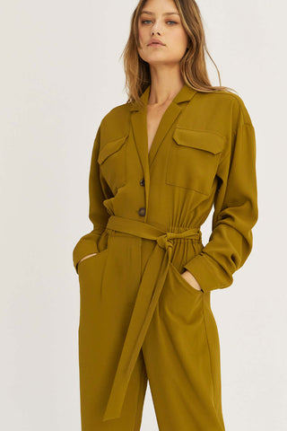 model wearing an olive jumpsuit with pockets