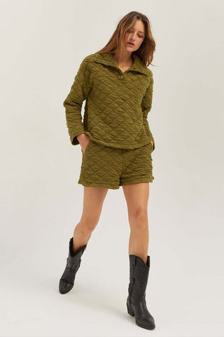 model wearing an olive quilted co-ord 
