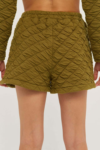 model wearing olive quilted shorts