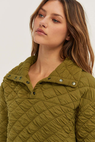 model wearing an olive quilted snap sweatershirt