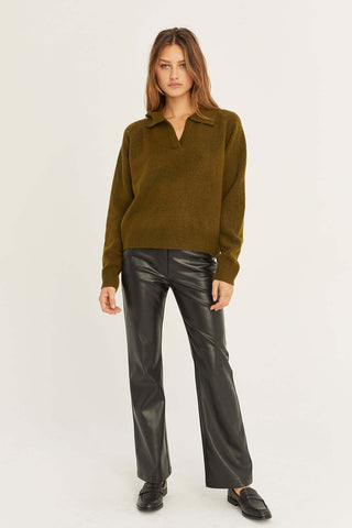 model wearing an olive sweater ensemble