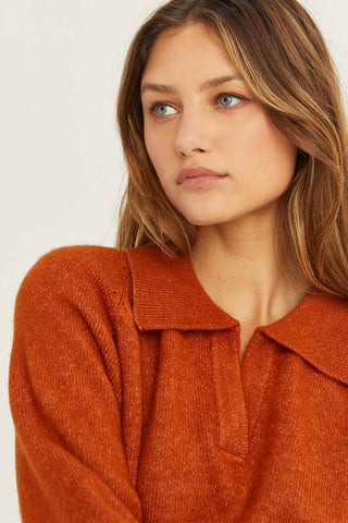 model wearing a red collared sweater