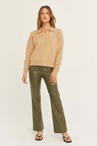 model wearing a sweater and leather pants