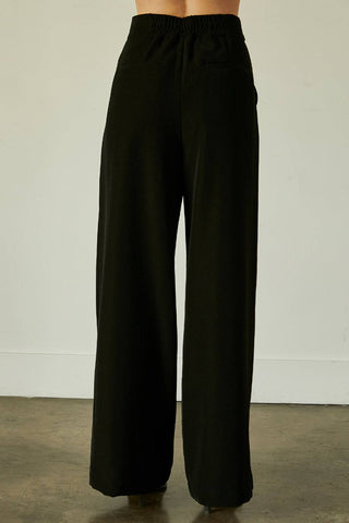 model wearing tailored women’s high-waisted pants