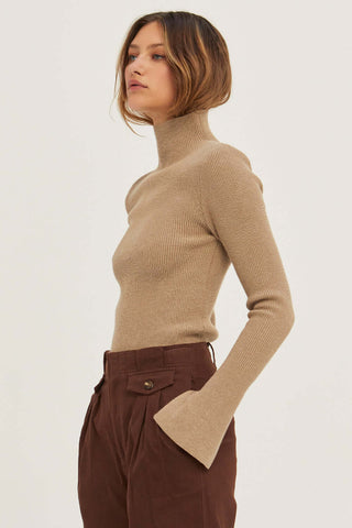 model wearing a taupe padded shoulder sweater