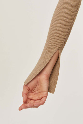 model wearing a taupe knit sweater with slit