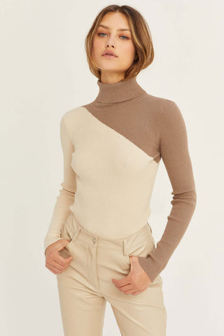model wearing a color block sweater in taupe and white