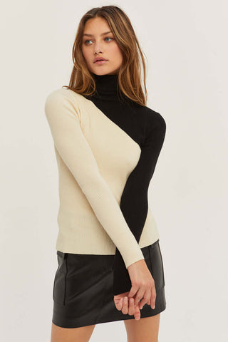 model wearing a two-tone color block turtleneck