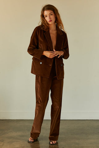 woman posing in brown corduroy blazer